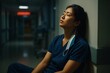 © taneat - Overworked Asian Nurse Resting in Hospital Corridor – Real Healthcare Emotion