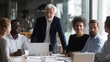 © Johannes - International executive team people having board meeting discussing project results. Diverse employees group working with senior leader brainstorming in office meeting room at presentation training.,