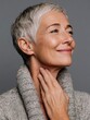 © Johannes - Senior woman with gentle smile touching neck, revealing natural skin texture, wrinkles highlighting aging process and authentic beauty