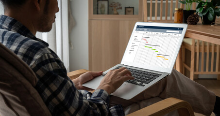 Project planning software for modish business project management on the computer screen showing timeline chart of the team project