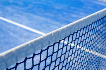 Detail of the white top band of a padel court net.