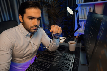 Working smart IT developer analyzing data software development on two pc screen, creating application program updated version online website page system online at neon light cyber office. Surmise.