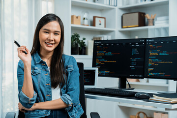 Wall Mural - young asian in it developer looking at camera to present with online information on pc with coding p
