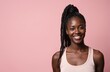 © miss irine - Young Black woman with braided hair wears tank top smiling against pink backdrop. Captures confidence, individuality, and simple beauty. Offers copy space for text.