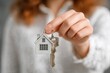 © SaroStock - Hand holds a small house model and a key, representing property ownership, suggesting a new home purchase, or illustrating real estate investment