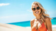 © shehroz khan - A beautiful blond woman in a bikini smiles on the beach under the summer sun, enjoying her ocean vacation