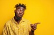 © LimeSky - Surprised young Black man gesturing sideways against a bright yellow backdrop