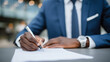 © Maksym - Focused shot of businessmanâs hand signing contract with pen on crisp white paper, elegant wristwatch visible, suggesting trust and partnership