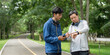 © itchaznong - Health and Wellness. Two men enjoying outdoor fitness activity in a park.
