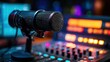 © bloombi - Mic on mixer with blurred background shows recording booth with glowing colored lights
