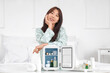 © Pixel-Shot - Beautiful young woman with mini cosmetic refrigerator on table at home