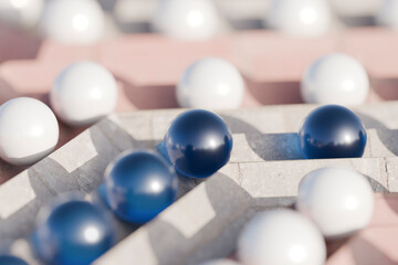 Abstract 3D marbles in blue and white on geometric maze background