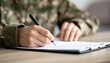 © photostockatinat - A military person in uniform is signing documents. A close up shot of the action