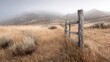 © fu - Weathered Wooden Fence Post in Dry Grassland with Foggy Hills. High quality