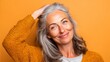 © Muhammad - Smiling Mature Woman with Grey Hair in Yellow Sweater
