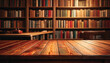 © Pickoloh - Wooden table in front of a blurred background of bookshelves filled with books background.