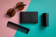 © Kisholoy - Flat lay composition of mens accessories including sunglasses, wallet, and comb on a pink and teal background