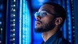 © Arvind - Cybersecurity analyst analyzing AI cyberspace threats on a computer in a dark tech office data center. The blue lighting sets a high-tech mood as a IT specialist engages ethical hacking, Generative AI