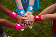 © kegfire - Colorfully dressed children join hands in a display of teamwork and harmony in nature.