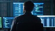 © Johnnii - A person sits in front of multiple screens displaying code and data, immersed in a technical environment.