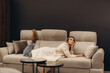 © Roman - Stylish Woman Relaxing on Modern Sofa in Minimalistic Interior
