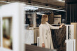 © Roman - Woman Examining Marble Slabs in a Modern Interior Design Showroom