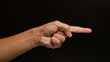 © Krakenimages.com - Man pointing finger against dark background showing a hand gesture