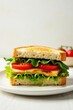 © tpadobestock - Delicate royal sandwich placed on a elegant white background with fresh greens and juicy tomatoes, clean, simple, royal