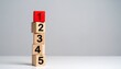 © Innovative - Vertical stack of numbered wooden blocks with red “1” on top, symbolizing priority and structured hierarchy