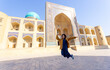 © LT - woman as a tourist have fun in front of Poi-Kalyan Kalyan mosque in bukhara Uzbekistan