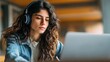 © Johannes - Hispanic teen girl, latin young woman school college student wear headphones learn watching online webinar webcast class looking at laptop elearning making notes or video calling remote teacher., no