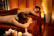 © InfiniteFlow - Caucasian couple customer enjoying relaxing anti-stress spa massage and pampering with beauty skin recreation leisure in warm candle lighting ambient salon spa at luxury resort or hotel. Quiescent