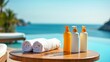 © TopPhoto - Spa bottles and rolled towels on wooden table by ocean view, relaxatio