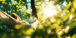 © THINGDSGN - Woman relaxing in hammock under warm sunlight in summer forest. Peaceful escape and mindfulness in nature