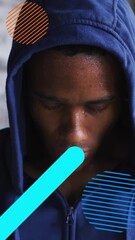 Sticker - digital composite video of abstract shapes moving against portrait of african american man