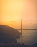 Golden gate bridge at sunset with a beautiful warm fog