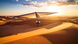 Hang gliding over Sahara Desert dunes at sunset.