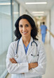 © Chondon - Smiling female doctor in hospital hallway with stethoscope