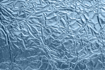 Wall Mural - shiny metallic blue foil crumpled texture background