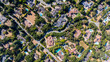 © Monet_P - Top-down aerial view of suburban homes with tennis courts, swimming pools, and leafy streets in an affluent residential area of Silicon Valley