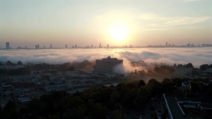 Wall Mural - araffature view of a city with a foggy sky and a sun