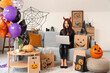 © Pixel-Shot - Young Asian woman dressed for Halloween with laptop shopping online at home