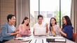 © Pichsakul - Asian business team adult professionals celebrating success looking laptop clapping cheering group people achieve victory modern office environment