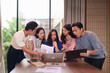 © Pichsakul - Asian business adults analyze shocking financial data collaboratively modern office workspace