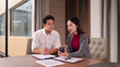 © Pichsakul - Asian business professionals collaborate discuss project details sharing information on smartphone during office meeting corporate environment
