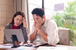 © Pichsakul - Adult Asian business colleagues experiencing work stress exhaustion frustration office problem solving project deadline pressure professional challenges meeting difficulties financial crisis