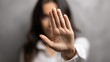 © Ketanoff - A woman holds up their hand to signal stop. Harassment at work. The setting appears dark, reflecting a serious atmosphere