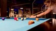 © Ina - Middle-age blonde woman holding arm on billiard table, playing snooker game or preparing aiming to shoot pool balls. sport game snooker billiards