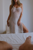 Passionate sexy young naked woman takes a shower and covers herself with a towel