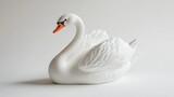 White swan figurine on white background. (1)